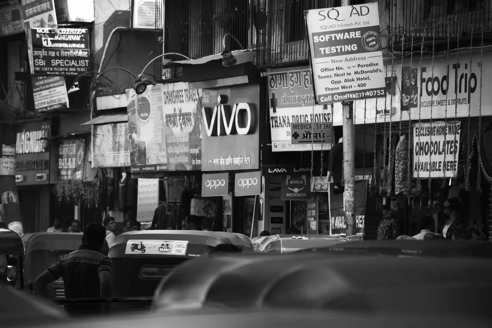 An Indian market street crowded with shop signboards